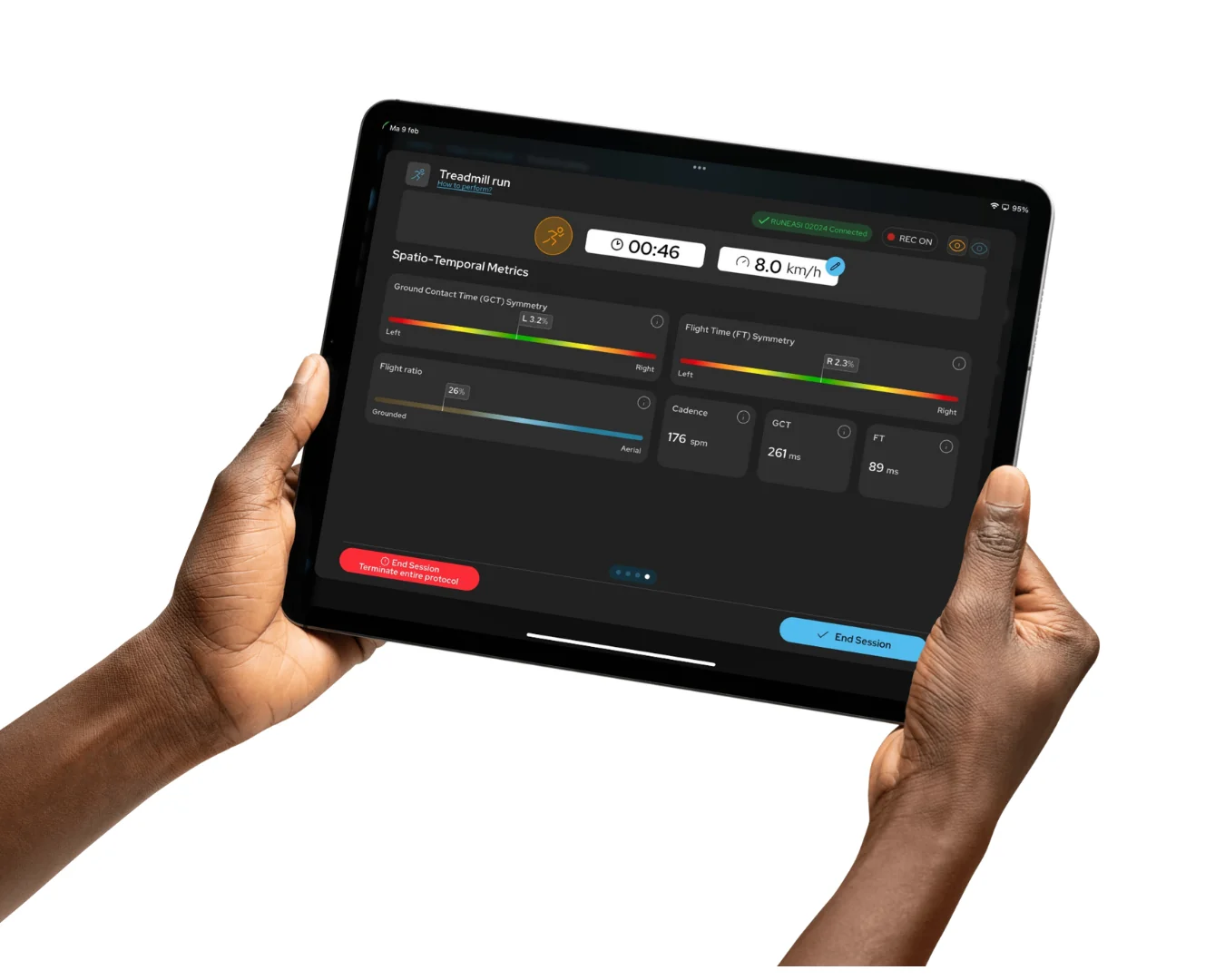 Two hands holding a tablet that shows live Runeasi data during a treadmill run