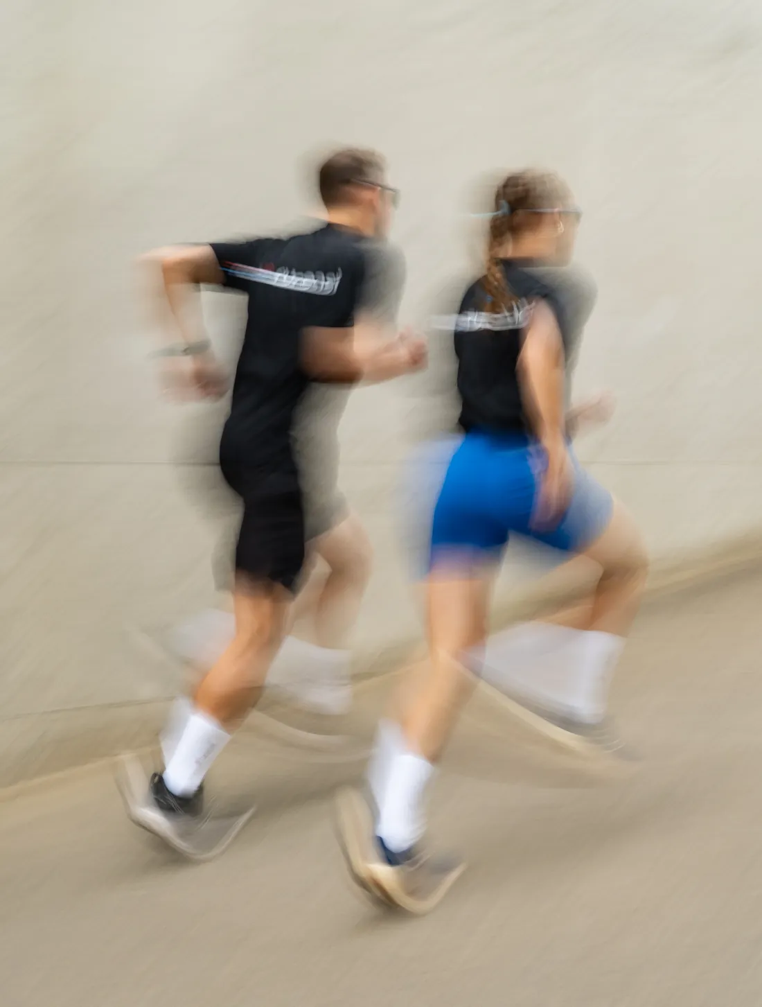 Two runners passing in a blur of motion